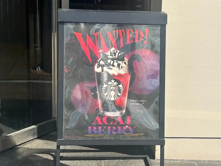 「スタバ新作 黒猫アサイーベリーフラペチーノ」の看板。秋限定・ハロウィン仕様のデザインで店頭に掲示されている。