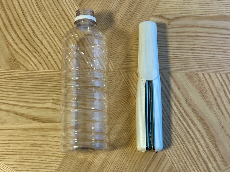 ペットボトルとフィンガーアイロンの大きさを比較している画像
