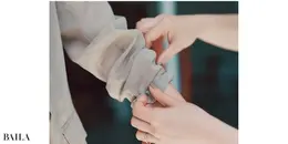 《2》袖口をゴムごとひじの下のあたりまで上げる。このとき、きれいに折りたたむのではなく、あえてくしゃっとラフにたくし上げるのがポイント